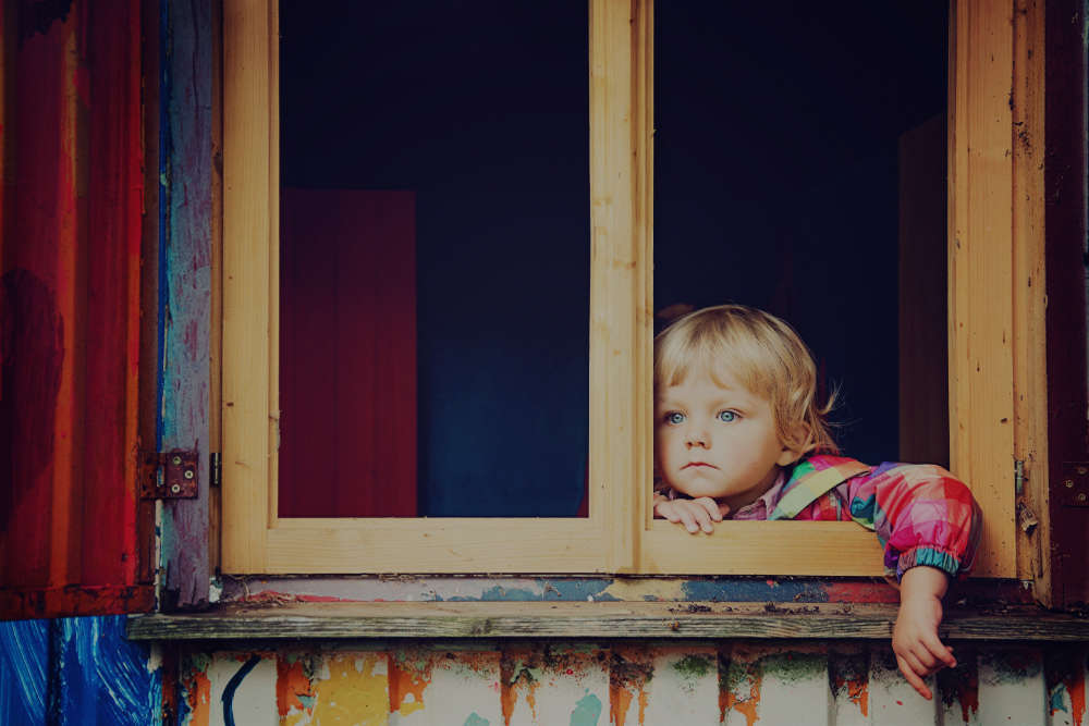 Small Blonde Child Gazing Out of a Window